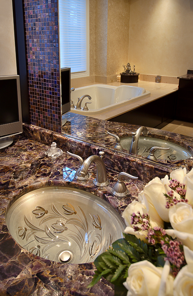 Stone top, undercount glass sink, pewter faucet, custom cabinetry