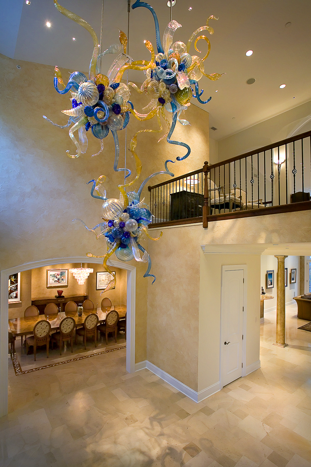Custom designed Chihuly fixture, dining room, foyer, brass and wood railing, faux finished walls